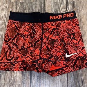 Red patterned Nike pros.